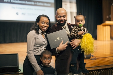 “Giving back is very important to me,” MIT staff member Greg Walton says. “I’ve had so many people invest their time and energy into helping me and so many others, so for me, I feel it would be an injustice not to do so.” Here, Walton celebrates with his family after receiving a 2017 MIT Excellence Award. 