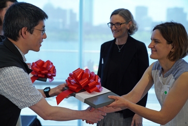 Professor Sara Ellison (center) and Professor Esther Duflo (right) receive an award from Professor Isaac Chuang for their work on "Data Analysis for Social Scientists.” Their course was awarded for the importance and relevancy of the topic, how the course is used in both the Data, Economics, and Development Policy MicroMasters program and for MIT undergraduate students, and how it provides stude...