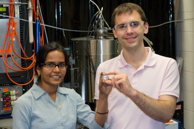 MIT postdoc Sulata Sahu (left) and graduate student Brian Chmielowiec hold a sample of nearly pure copper deposited on an iron electrode. 