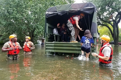 Texas Army National Guardsmen help Houston residents affected by flooding caused by Hurricane Harvey board a military vehicle. "With an event like this," says MIT associate professor of urban planning Brent Ryan, "it becomes viscerally evident which residential areas are absolutely not safe from even moderate flooding."