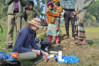 PhD student Britt Huhmann measures arsenic in rice paddy soil using a field kit in Faridpur, Bangladesh.
