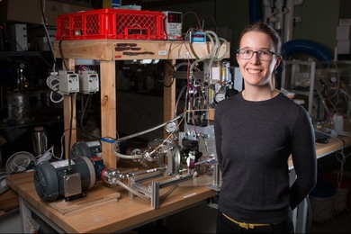 Emily Tow PhD '17, displays equipment she developed to measure the effects of different pressure levels on the way microorganisms build up on membranes used for desalinating water.