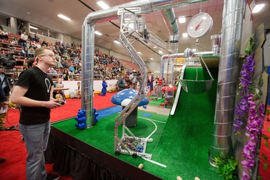 John Taylor Novak, a mechanical engineering junior, navigates his robot "Red Eye" through the game board at Thursday’s competition.  