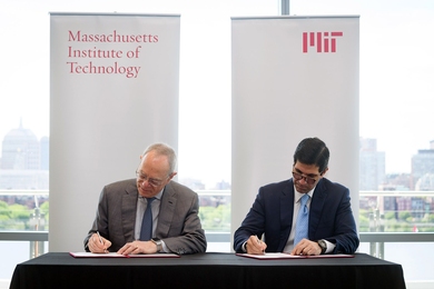 MIT President L. Rafael Reif (left) and Talal Shair sign documents related to the collaboration between the Dar Group and MIT. 
