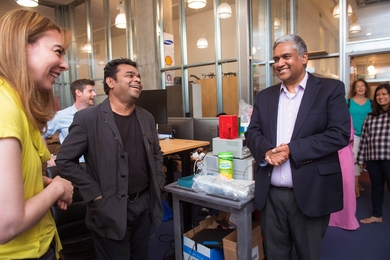 MIT professor of electrical engineering and computer science Dina Katabi (far left) gives a tour of her lab to A.R. Rahman (center) and Anantha Chandrakasan (right), dean of the School of Engineering.