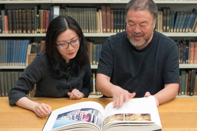 Artist Ai Weiwei (right) and Christina Yu Yu, the Matsutaro Shoriki Chair of the Art of Asia at the Museum of Fine Arts, Boston, examine Ai's pictorial autobiography “Ai Weiwei: Beijing Photographs, 1993 – 2003” at a recent launch event.