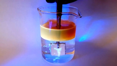 Researchers demonstrating the ability of aluminum to repel oil underwater.