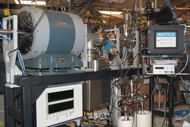 The ion beamline at Sandia National Labs where the new radiation damage measurement system has been installed and tested. The radiation damage process is observed in a target chamber located behind the black-box laser enclosure on the right of the image. 