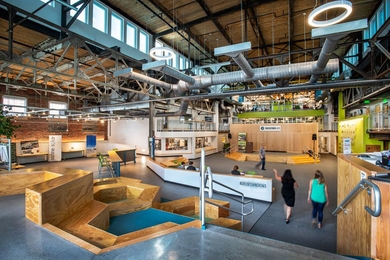 Greentown Labs is the largest clean technology incubator in North America by both square feet and the number of member companies. The open layout of its entrance, shown here, is designed to host events and encourage collaboration.