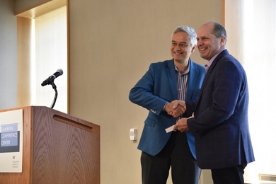 Chris Caplice (right) receives the MITx Prize for Teaching and Learning with MOOCs from Krishna Rajagopal in 2018.