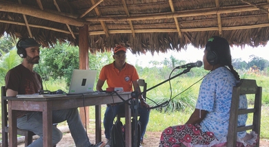 Eduardo Undurraga, an assistant professor at the Pontifical Catholic University of Chile, runs a musical pitch perception experiment with a member of the Tsimane’ tribe of the Bolivian rainforest.