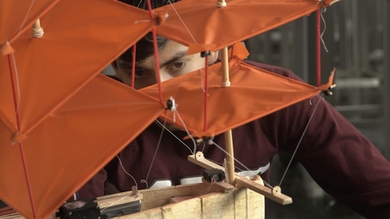 Rodrigo Vasquez examines his team's final project, a plane that also acts a boat on water.