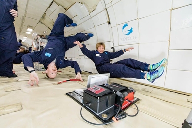 Chris Carr and Maria Zuber of the MIT Department of Earth, Atmospheric and Planetary Sciences have a little fun while monitoring their life-detection data experiment in microgravity.