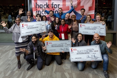 The three winning teams from the Hack for Inclusion 2020 and the crowd's favorite pose with their checks. 