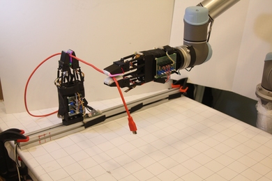 The system uses a pair of soft robotic grippers with high-resolution tactile sensors to successfully manipulate freely moving cables.