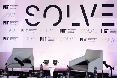 Photo of empty chairs before the Solve logo