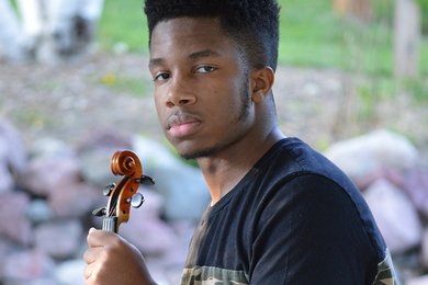 Headshot of Xzavier Herbert holding a violin
