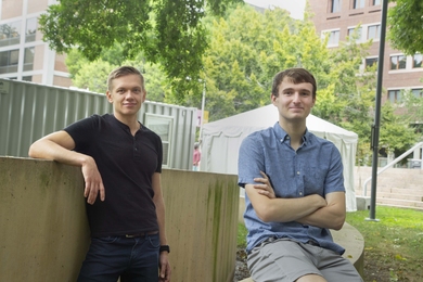 Photo of Ivan Goryachev and Ryan Koeppen standing in front of MIT Medical