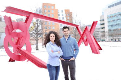 Photo of Ava Soleimany and Alexander Amini standing together in the snow outside MIT's Stata Center. 