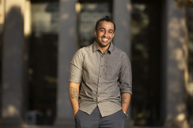 Arnav Patel on MIT's campus, smiling and with his hands in his pockets