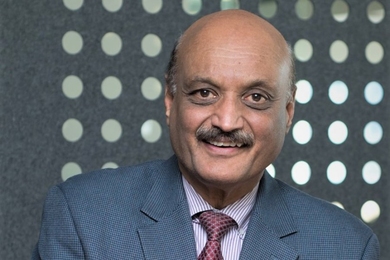 Portrait photo of Bhaskar Pant wearing a suit and tie, smiling