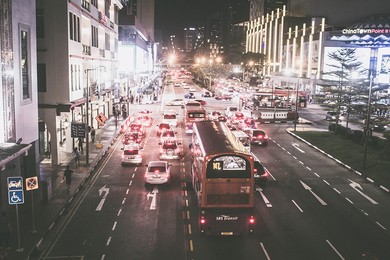 Traffic on a busy Singapore street at night