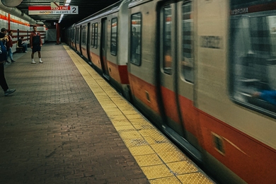 Photo of a Red Line MBTA subway train arriving at an underground station