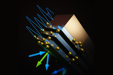 A cube with stripes representing layers of semiconductors, with clusters of gold spheres representing nanodots