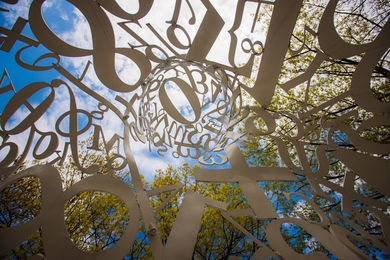 Photo of mathematical symbols and numbers from inside a sculpture of a person made out of these symbols