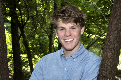 portrait photo of student Ryan Conti in a woodsy setting