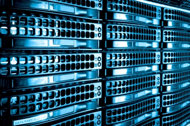 Close-up photo of a rack of computer servers, stylized so they appear in a blue hue