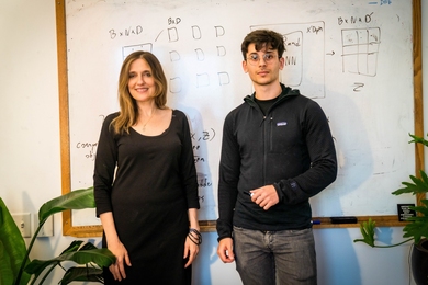 Photo of Regina Barzilay and Adam Yala standing side-by-side before a whiteboard