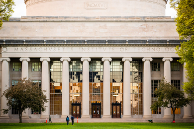 View of MIT's Great Dome, with light reflecting off the windows behind the columns along the front of the building