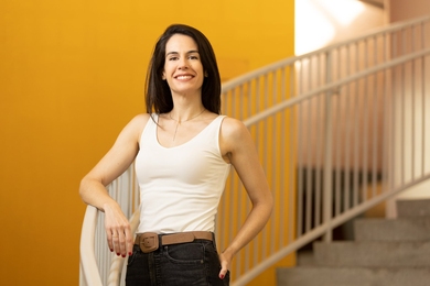 Portrait photo of Juncal Arbelaiz Mugica standing on a curving staircase