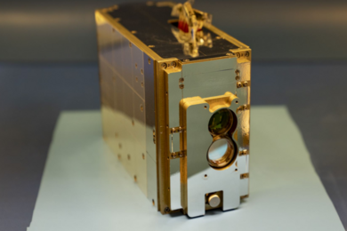 Photo of a golden rectangular metal box, roughly the size of a tissue box.