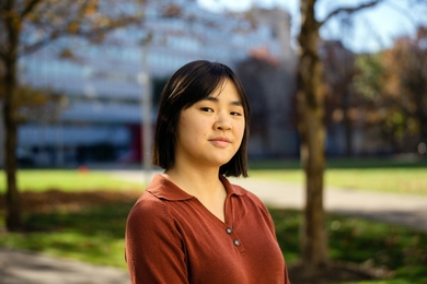 Teresa Gao stands outdoors with the background out-of-focus
