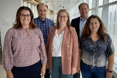 Five MIT.nano staff and members of the UpNano team pose standing in a hallway.