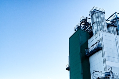 Photo of a corner of a chemical plant against a blue sky