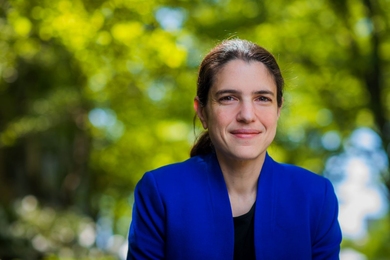 Heather Kulik poses outside in front of green trees