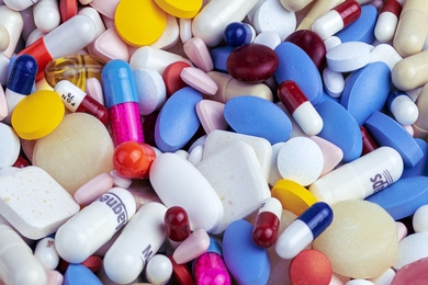 A pile of different pharmaceutical pills and capsules