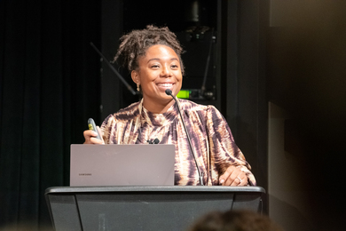 Closeup of Tiera Fletcher speaking at a lecturn