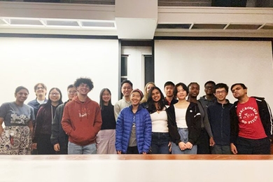 16 students line up in two rows for a photo