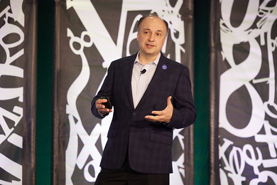 Large white numbers and mathematical symbols appear behind him.
