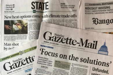 Photo of the partial front pages of four newspapers