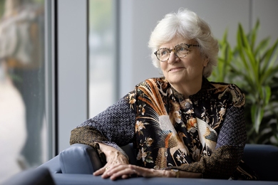 Nancy Hopkins, seated, looks out a window