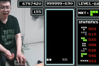 A split-screen shows two halves of a video game screen. On left, Justin Yu responds to his game with shock; on right, the game screen itself shows only two blocks.
