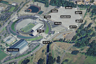 An aerial view shows trees and sports stadiums and parking lots. The areas are measured with a road measuring “921.97ft” and a parking lot measuring, “614,232.74 ft squared.”