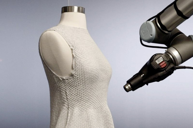 Close-up of a dress neckline on a mannequin being targeted by a laser