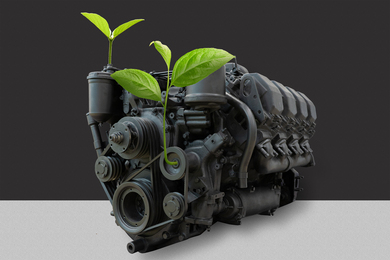 An old diesel engine with young plants sprouting from it