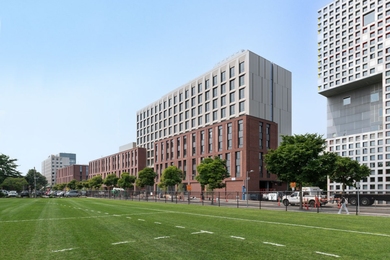 The brick-and-cement Graduate Junction building, seen from playing fields across the street